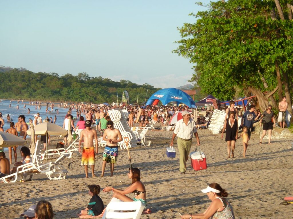 Playa Tamarindo crowded with beach chairs and umbrellas during Christmas week